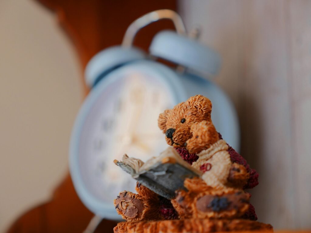 Selective Focus Photography of Bears Reading Book Figurine