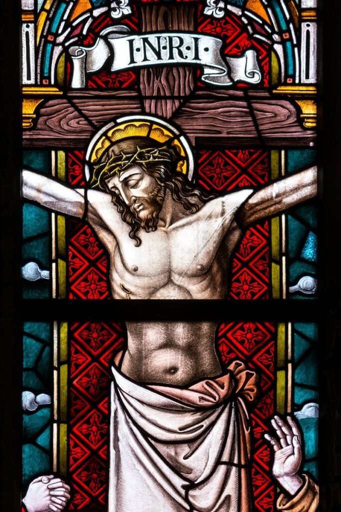 pexels-photo-208216-208216 Detailed stained glass depiction of the crucifixion featuring Christ and religious icons.
