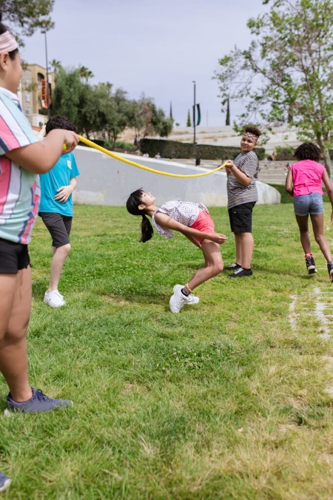 pexels-photo-8034605-8034605 Group of kids enjoying limbo game during a summer camp in the park, fostering fun and teamwork.