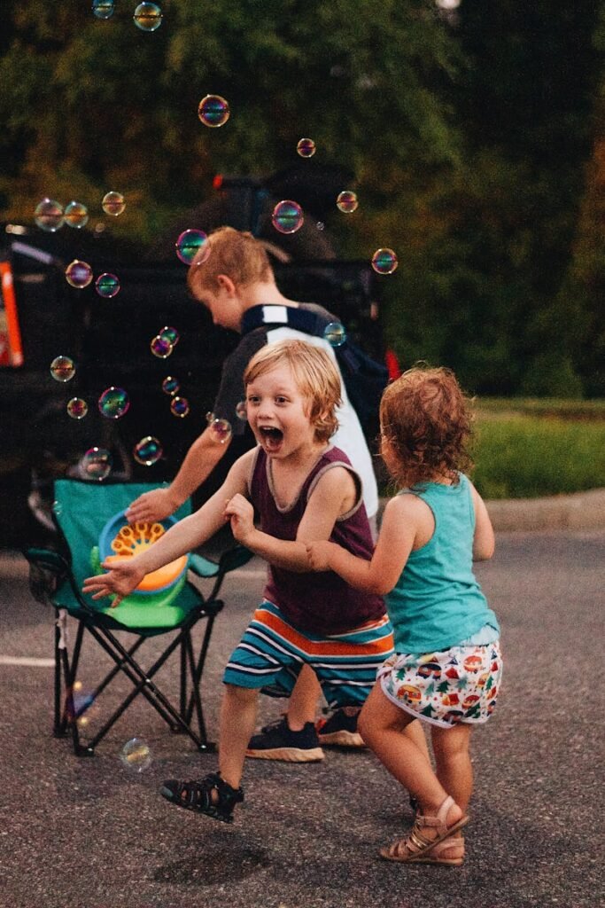 pexels-photo-30388483-30388483 Kids having fun with bubble machine during a summer outdoor gathering.
